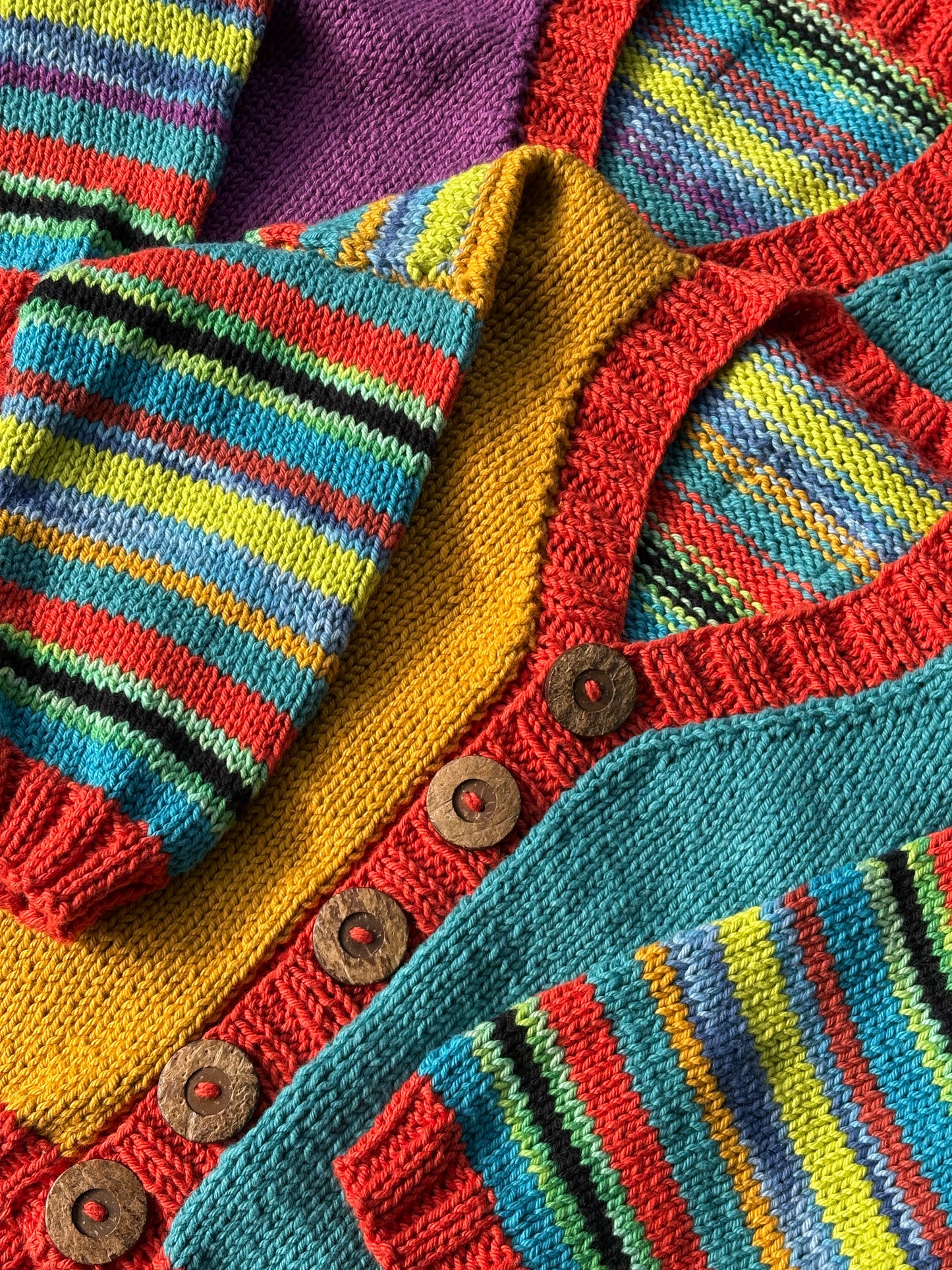 Close-up of a colorful knitted garment with buttons